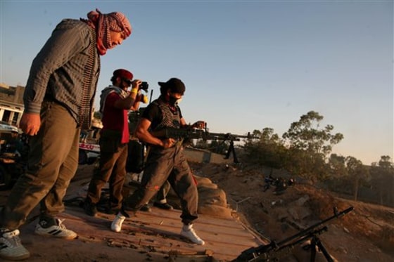 A Libyan rebel fighter fires a machine gun on the front line, west of Misrata, in Libya on May 28. The new rebel administration on Saturday warned it was fast running out of money because countries that promised financial aid have not come through.